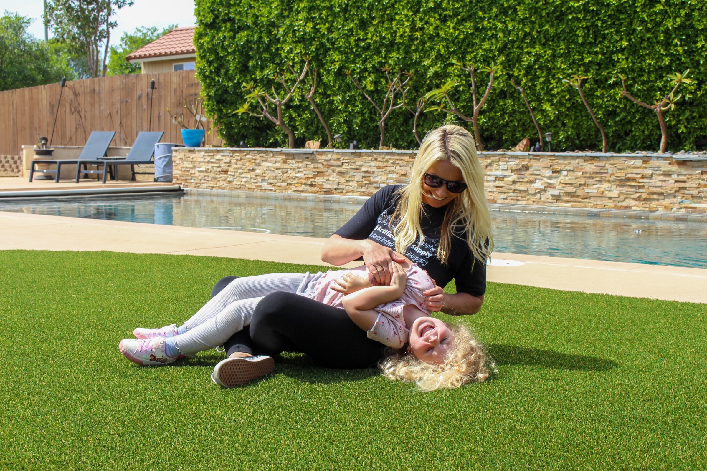 Mom and daughter on turf